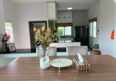 Modern kitchen with stylish decor and open layout, featuring sleek appliances and elegant dining area.