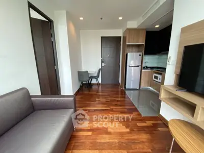 Modern apartment interior with wooden flooring and compact kitchen