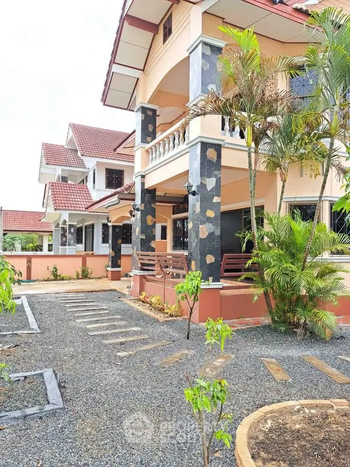 Charming two-story house with lush garden and modern architecture in a serene neighborhood.