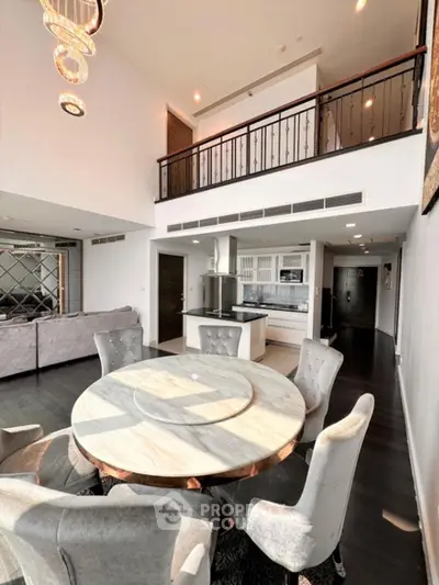 Luxurious open-plan living room with elegant dining area and modern kitchen in a stylish duplex apartment.