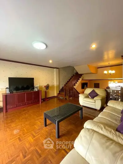 Spacious living room with elegant wooden flooring and modern furniture