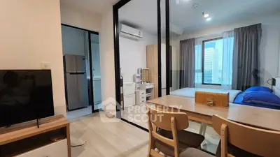 Modern studio apartment with open layout, featuring a cozy bedroom, dining area, and compact kitchen.