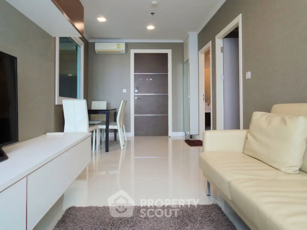 Modern living room with sleek furniture and elegant decor in a stylish apartment.