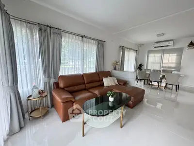 Spacious living room with modern furniture and large windows for natural light.