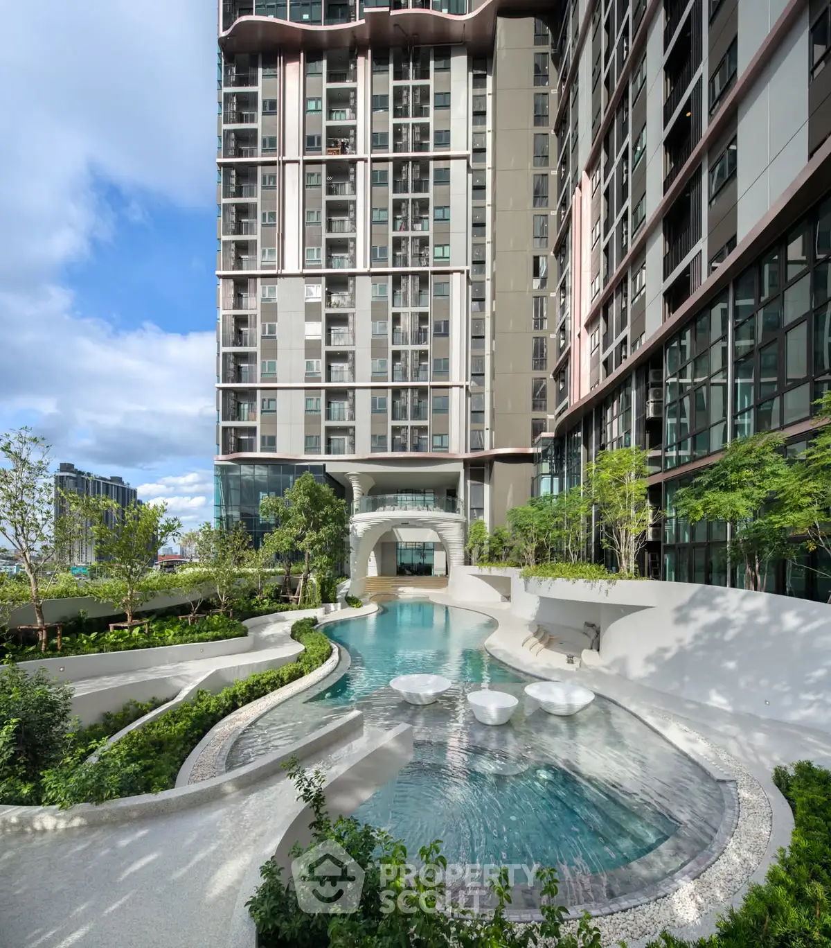 Luxurious modern building with stunning pool and lush garden view