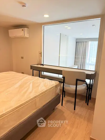 Modern bedroom with large window and study desk, featuring natural light and minimalist design.