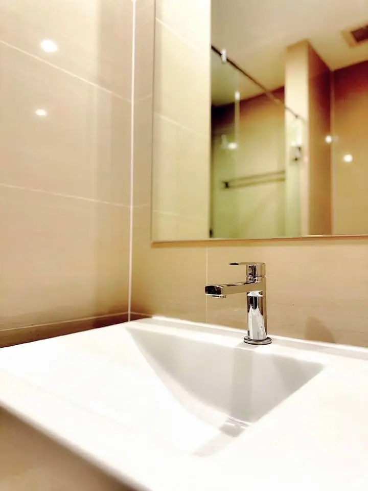Modern bathroom with sleek sink and elegant mirror in contemporary design.