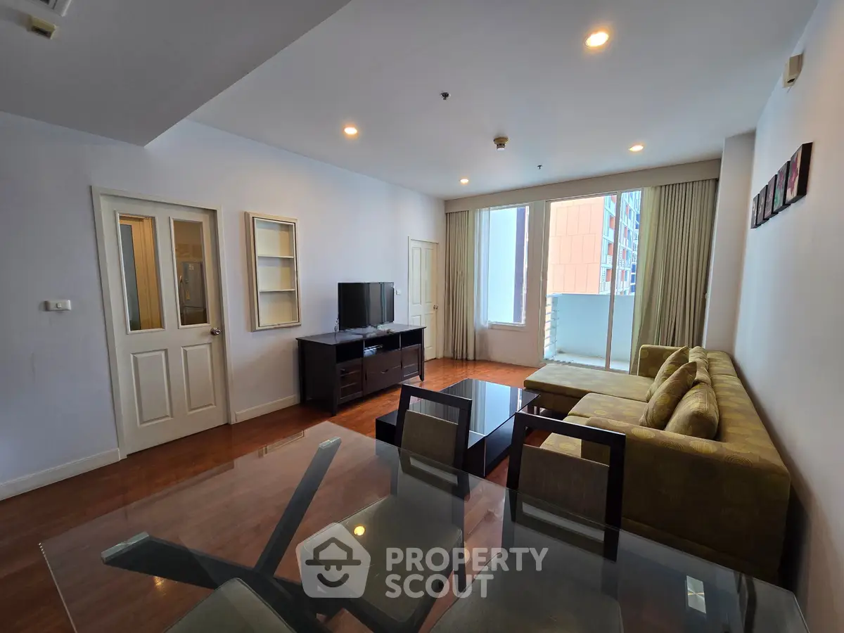 Spacious living room with modern furniture and large windows in a stylish apartment.