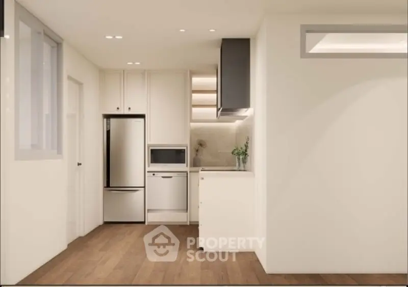 Modern minimalist kitchen with sleek cabinetry and stainless steel appliances.