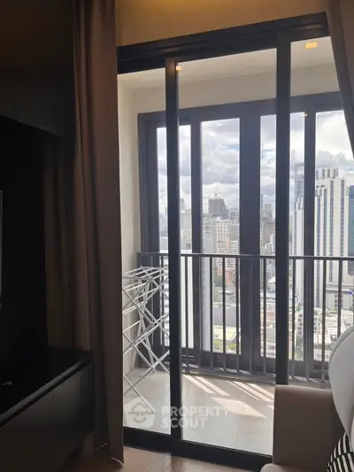 Modern apartment with balcony offering stunning city skyline views, perfect for urban living.