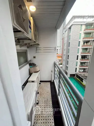 Charming balcony with city view and laundry area in modern apartment