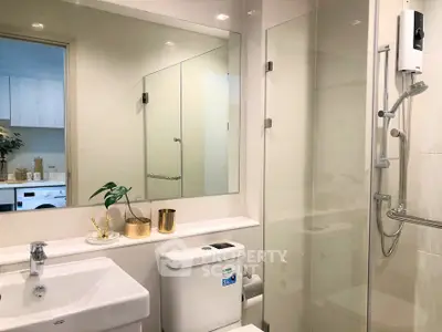 Modern bathroom with sleek fixtures and glass shower enclosure