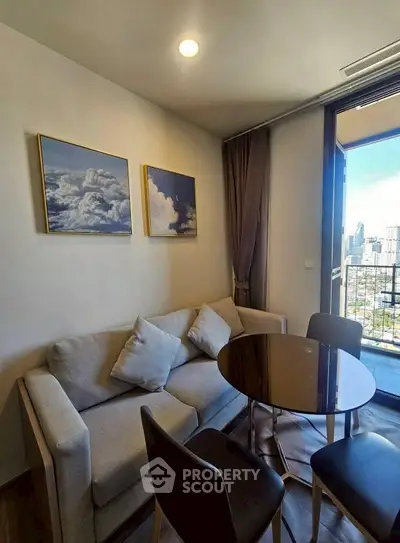 Cozy living room with city view, modern decor, and balcony access.