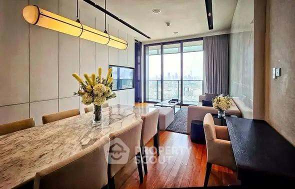 Luxurious dining and living area with city view, elegant decor, and modern furnishings.