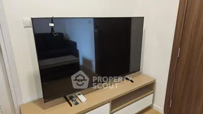 Modern living room with sleek TV and stylish wooden cabinet