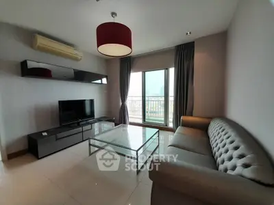 Modern living room with city view, stylish furniture, and large window.