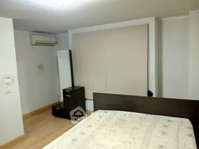 Cozy bedroom with air conditioning and modern furniture in a stylish apartment.