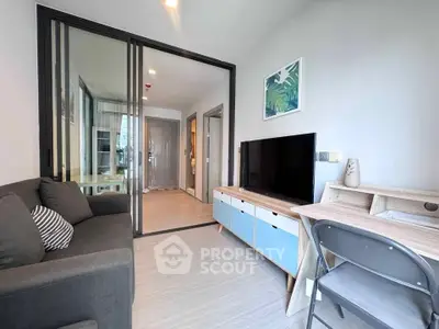 Modern living room with sleek furniture and glass partition in a stylish apartment.