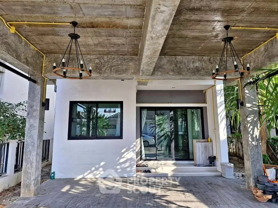 Modern concrete exterior with stylish lighting and large windows in a contemporary home.