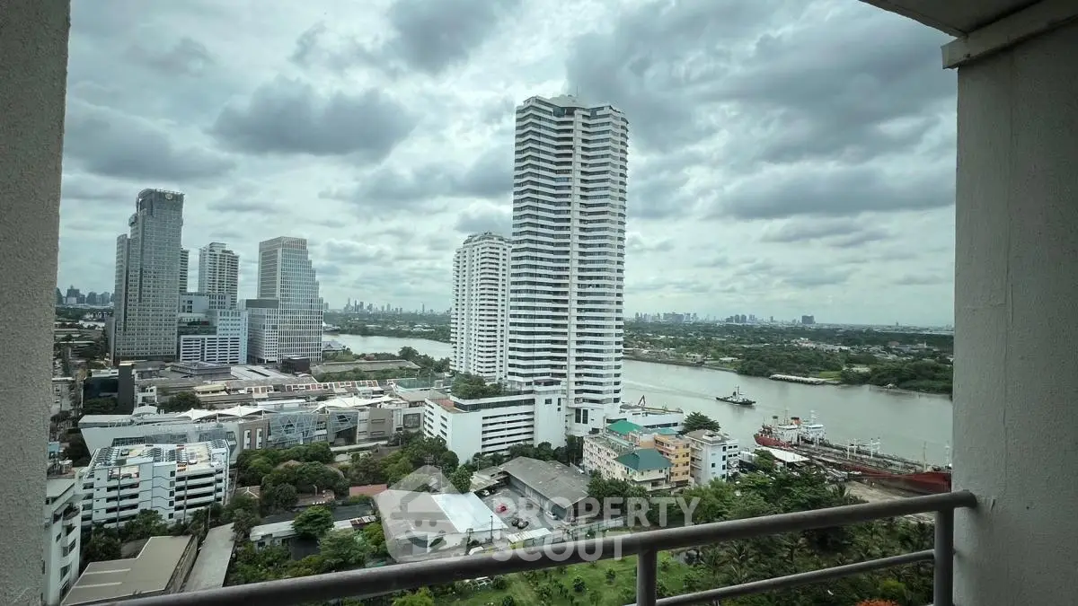 Stunning river and cityscape view from high-rise balcony in urban setting.