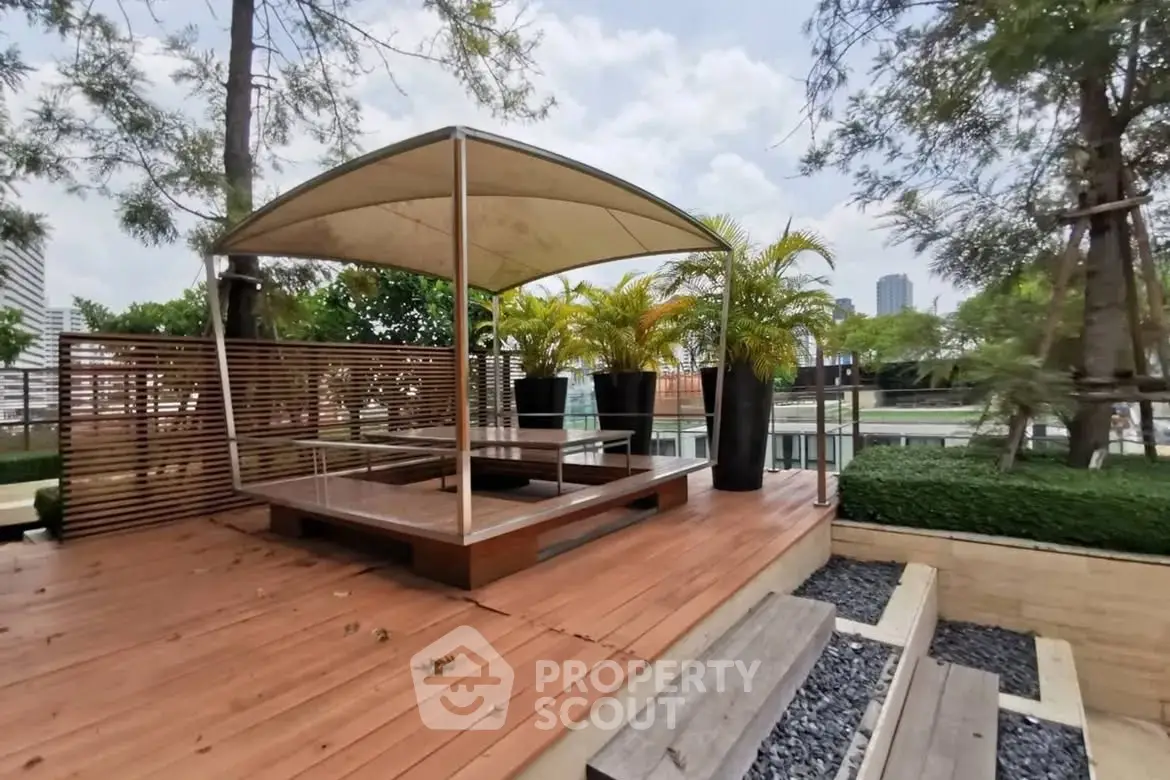 Stylish outdoor terrace with modern seating and lush greenery in urban setting.