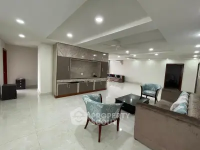 Spacious modern living room with elegant furniture and recessed lighting