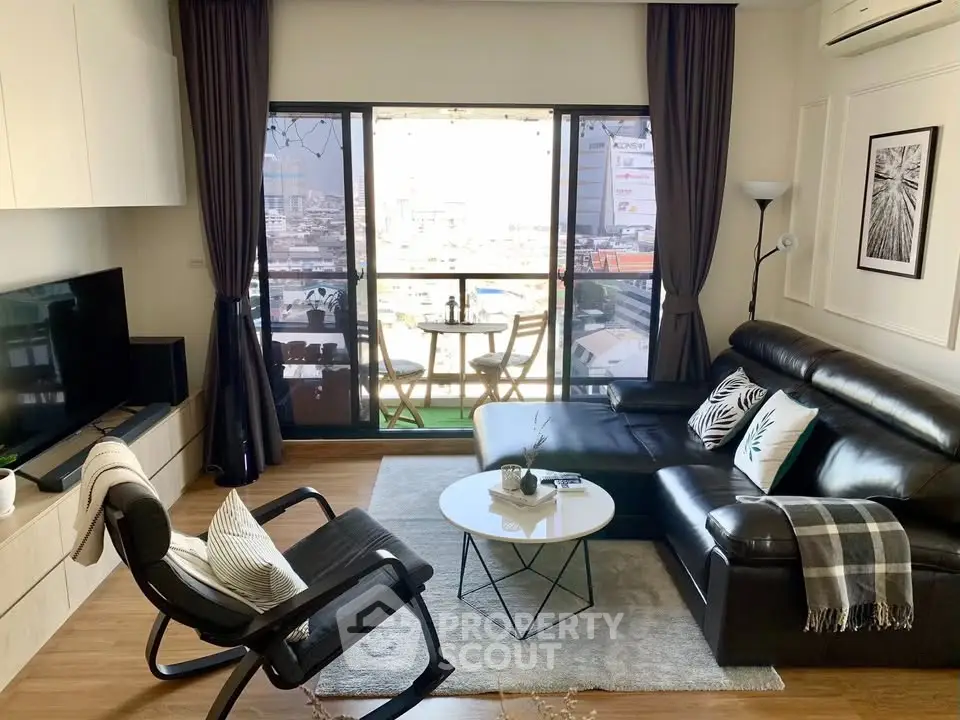 Modern living room with leather sofa and city view balcony