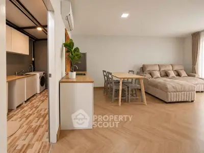 Spacious open-plan living room with modern kitchen and cozy seating area