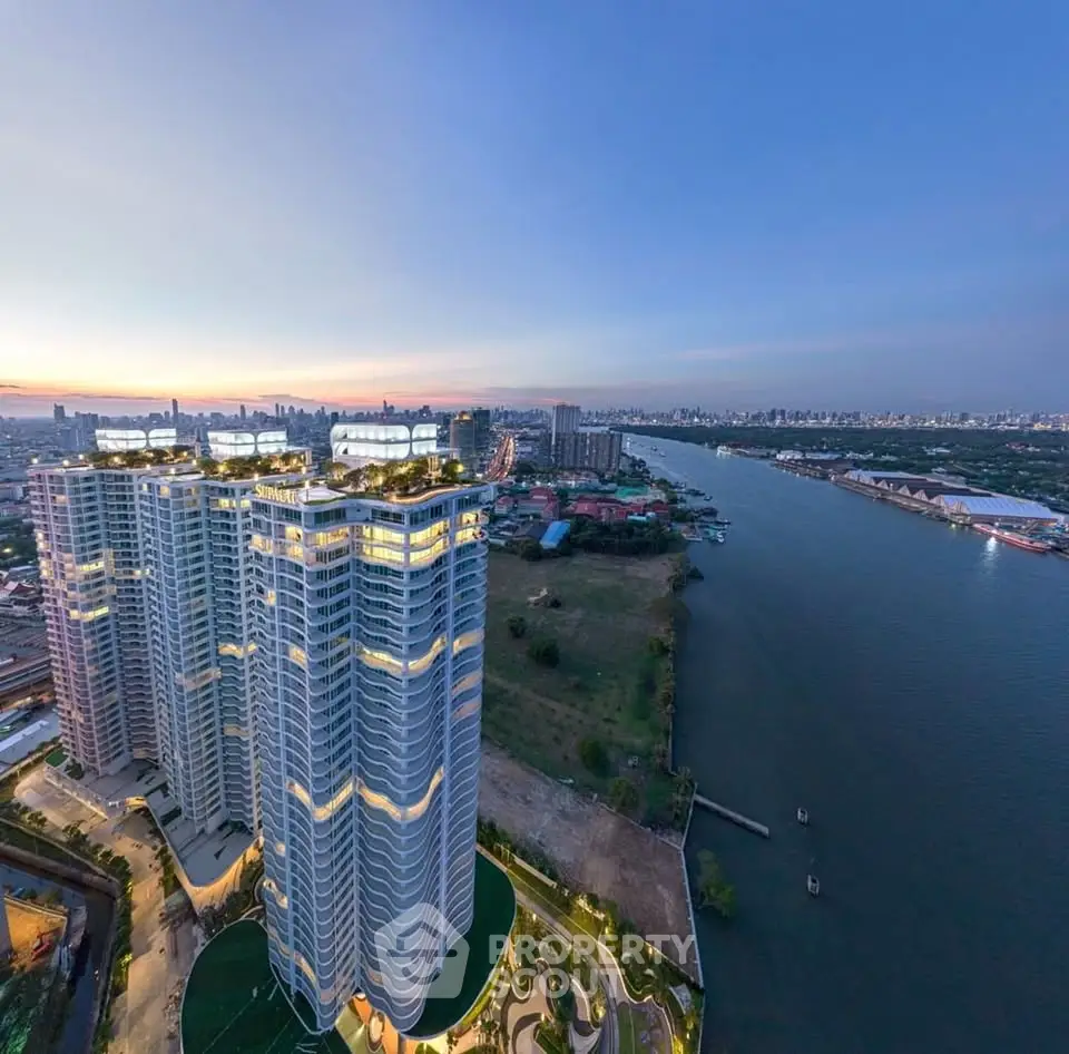 Stunning high-rise building with river view at sunset, showcasing modern architecture and prime location.