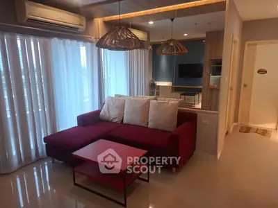 Modern living room with red sofa and stylish lighting in a cozy apartment