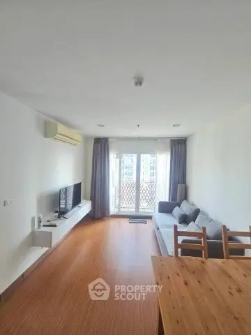 Spacious living room with modern decor and large windows for natural light.