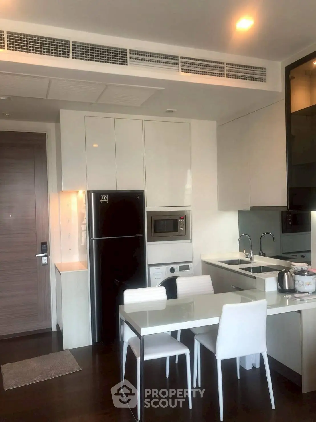 Modern kitchen with sleek appliances and dining area in a stylish apartment