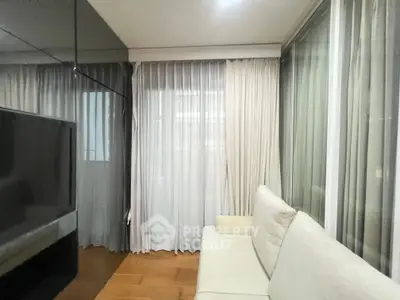 Modern living room with sleek design and floor-to-ceiling windows for natural light.