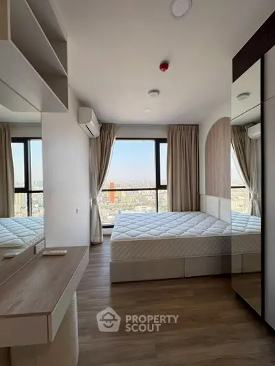 Modern bedroom with city view, featuring large windows and minimalist design.