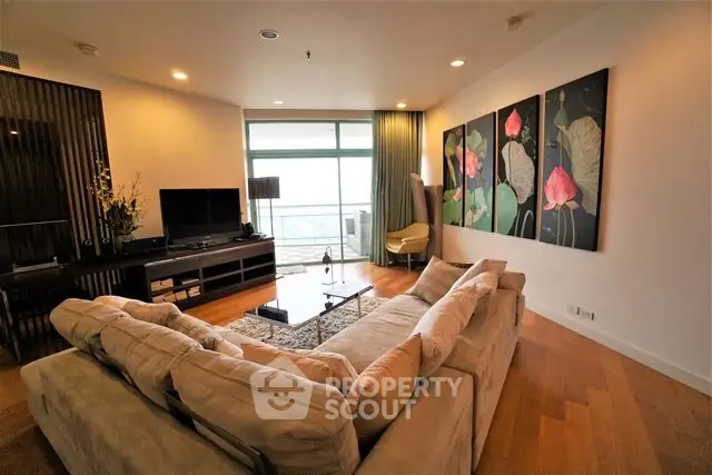 Spacious living room with modern decor and large windows offering a stunning view.