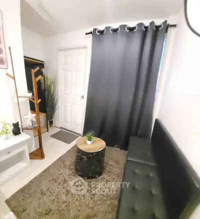 Cozy small living room with modern decor and black curtains