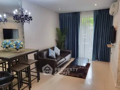 Stylish living room with elegant decor, leather sofa, and modern dining area.