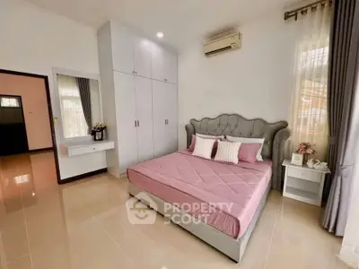 Elegant bedroom with stylish bed and built-in wardrobe, perfect for modern living.