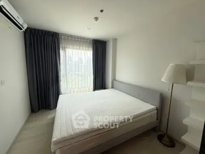 Spacious bedroom with city view, modern furnishings, and ample natural light.