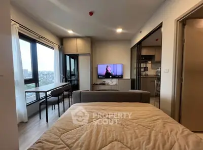 Modern studio apartment with city view, cozy living area, and open kitchen layout.