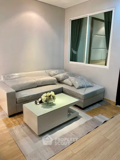 Modern living room with stylish sofa and coffee table, perfect for cozy gatherings.