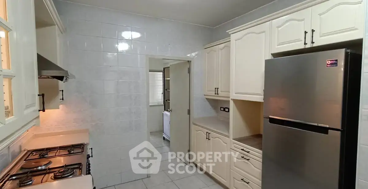 Spacious kitchen with modern appliances and closed layout in elegant home.