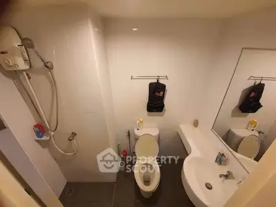 Compact bathroom with shower and modern fixtures in urban apartment
