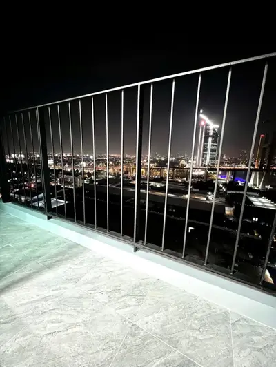 Stunning cityscape view from a modern balcony at night, perfect for urban living.