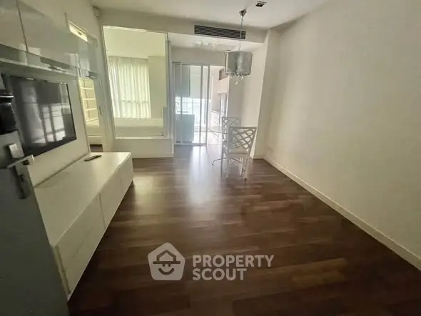 Modern living room with sleek flooring and stylish furniture in a contemporary apartment.