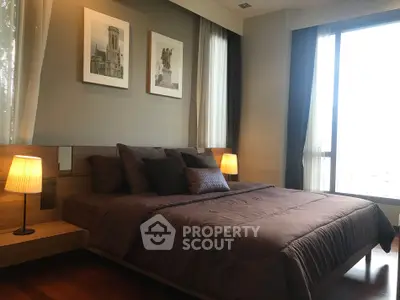 Luxurious bedroom with elegant decor and large windows offering natural light.