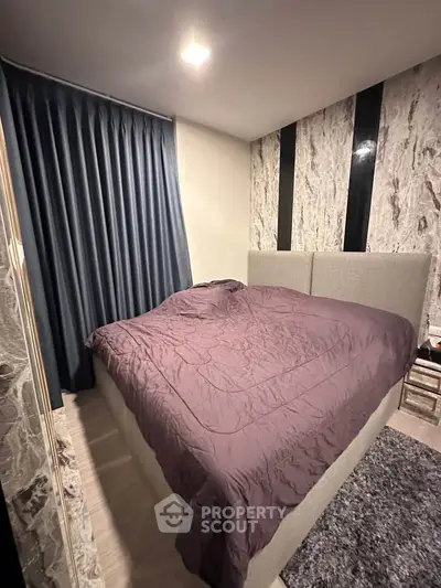 Cozy bedroom with modern decor and plush bedding in a stylish apartment.