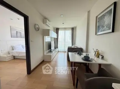 Modern apartment interior with open living and dining area, featuring stylish decor and natural light.