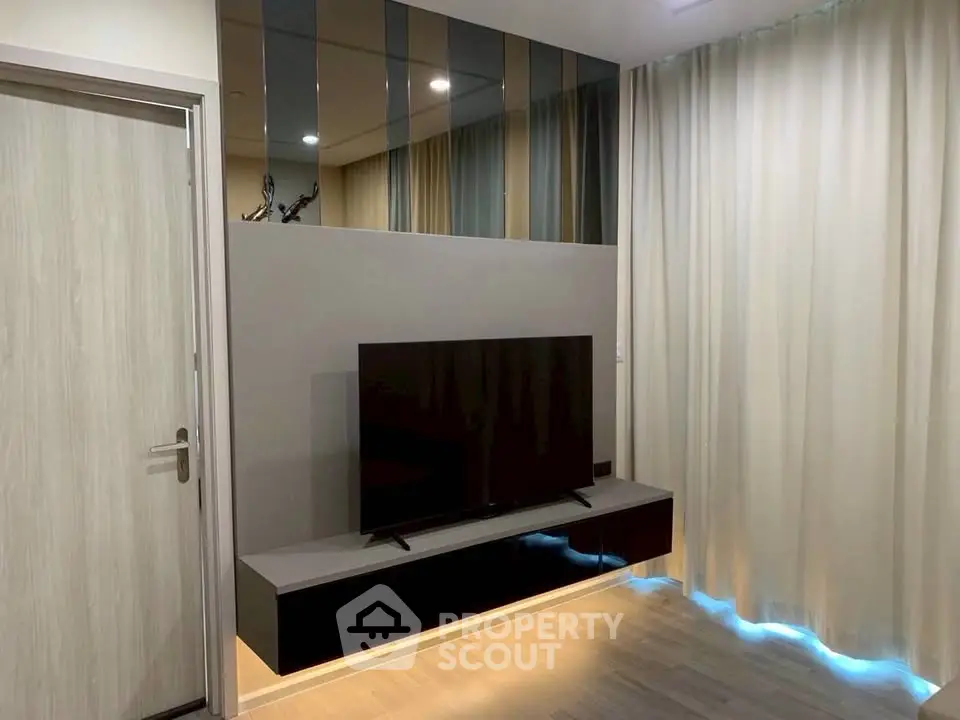 Modern living room with sleek TV setup and elegant curtains