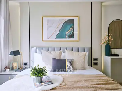 Stylish bedroom with modern decor and elegant artwork above bed